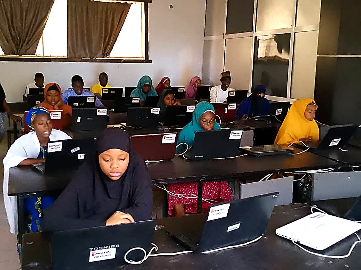 Students training on laptops at Pioneers ICT